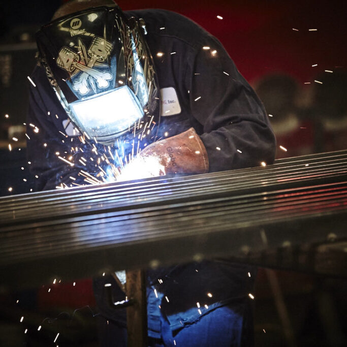 man welding with sparks
